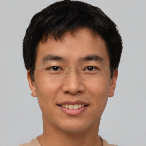 Joyful asian young-adult male with short  brown hair and brown eyes