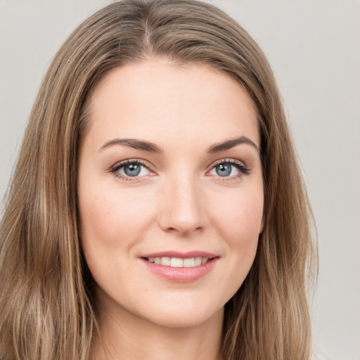 Joyful white young-adult female with long  brown hair and green eyes