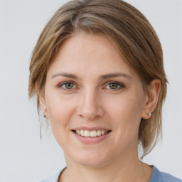 Joyful white young-adult female with medium  brown hair and grey eyes