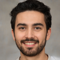 Joyful white young-adult male with short  black hair and brown eyes