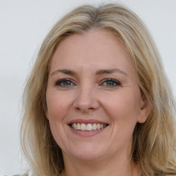 Joyful white adult female with long  brown hair and brown eyes