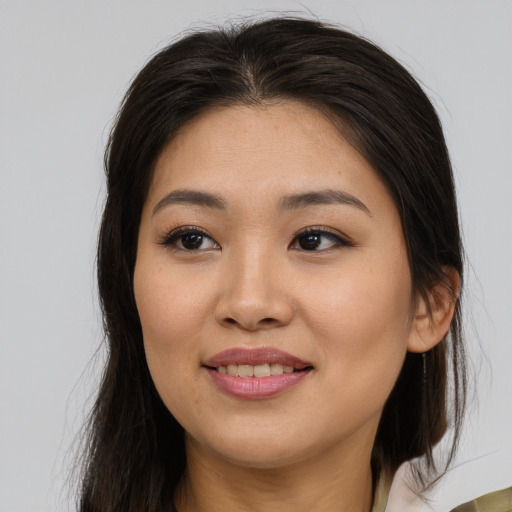 Joyful asian young-adult female with long  brown hair and brown eyes