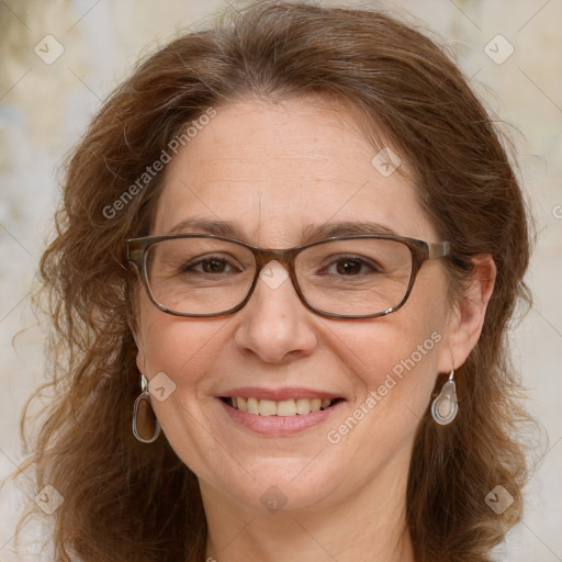 Joyful white adult female with long  brown hair and blue eyes