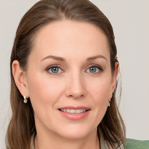 Joyful white young-adult female with medium  brown hair and blue eyes