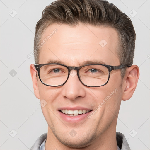 Joyful white adult male with short  brown hair and brown eyes