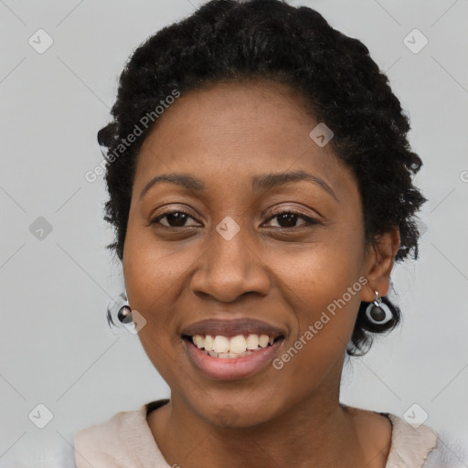 Joyful black young-adult female with short  black hair and brown eyes