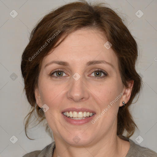 Joyful white adult female with medium  brown hair and blue eyes