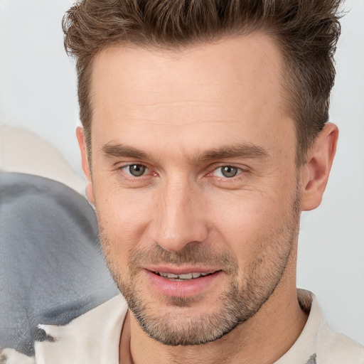 Joyful white adult male with short  brown hair and brown eyes