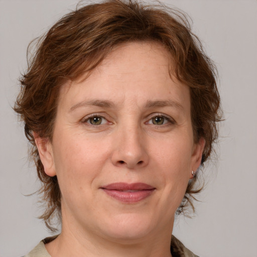 Joyful white adult female with medium  brown hair and grey eyes