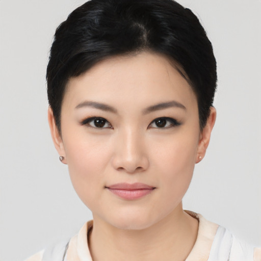 Joyful asian young-adult female with short  black hair and brown eyes
