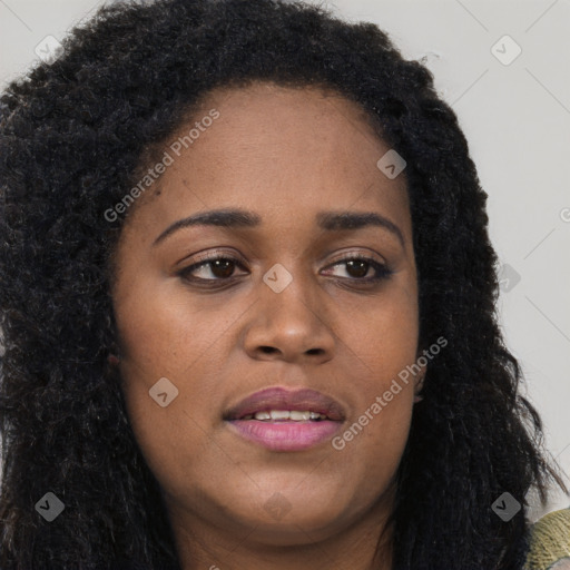 Joyful black young-adult female with long  brown hair and brown eyes