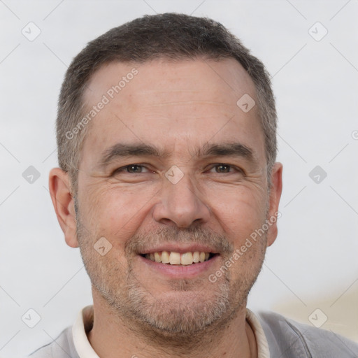 Joyful white adult male with short  brown hair and brown eyes