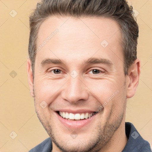 Joyful white adult male with short  brown hair and brown eyes