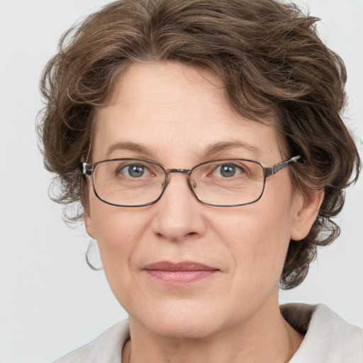 Joyful white adult female with medium  brown hair and blue eyes