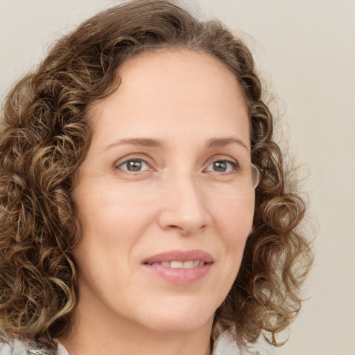 Joyful white young-adult female with medium  brown hair and green eyes