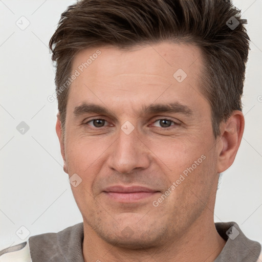 Joyful white adult male with short  brown hair and brown eyes