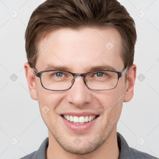 Joyful white young-adult male with short  brown hair and grey eyes