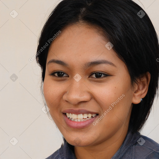 Joyful latino young-adult female with medium  brown hair and brown eyes