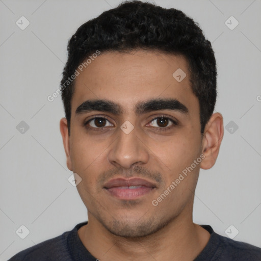 Joyful latino young-adult male with short  black hair and brown eyes