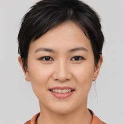 Joyful asian young-adult female with short  brown hair and brown eyes