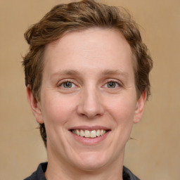 Joyful white adult female with medium  brown hair and grey eyes