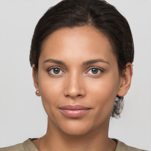 Joyful latino young-adult female with short  brown hair and brown eyes