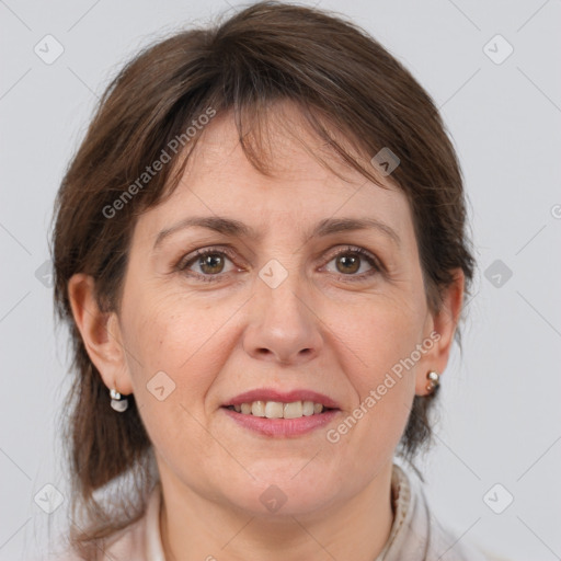 Joyful white adult female with medium  brown hair and grey eyes