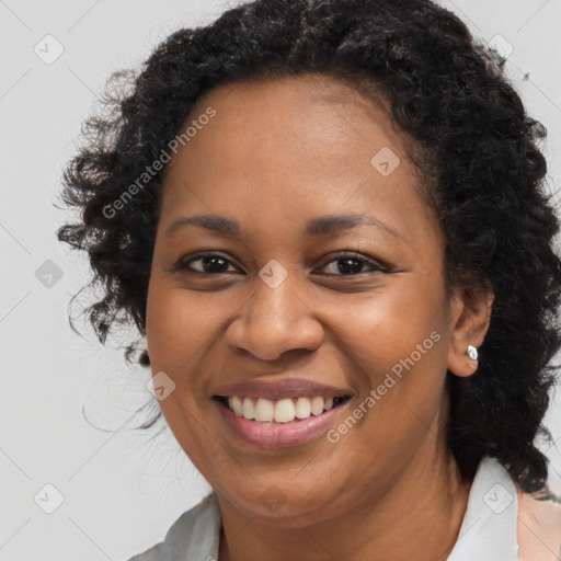 Joyful black adult female with medium  brown hair and brown eyes