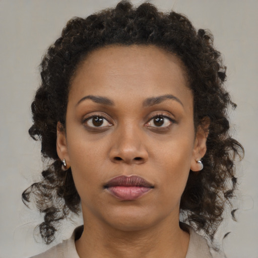Neutral black young-adult female with medium  brown hair and brown eyes