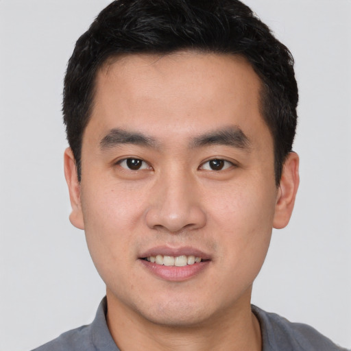 Joyful white young-adult male with short  black hair and brown eyes