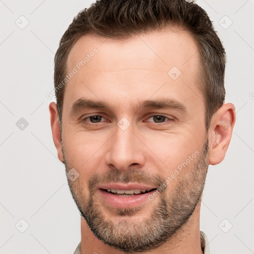 Joyful white young-adult male with short  brown hair and brown eyes