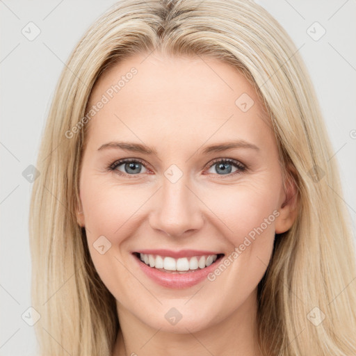 Joyful white young-adult female with long  brown hair and blue eyes