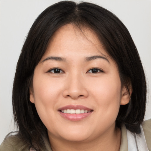 Joyful white young-adult female with medium  brown hair and brown eyes