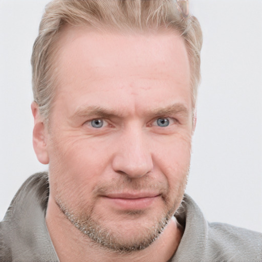 Joyful white adult male with short  brown hair and blue eyes