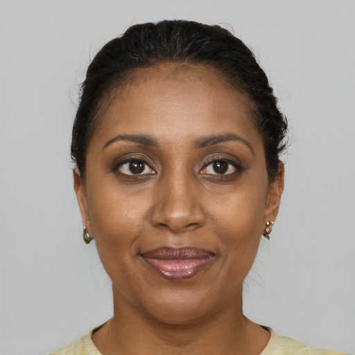 Joyful black adult female with short  black hair and brown eyes