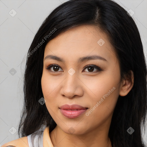 Joyful latino young-adult female with long  brown hair and brown eyes