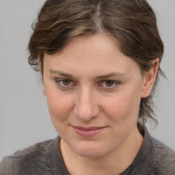 Joyful white adult female with medium  brown hair and grey eyes