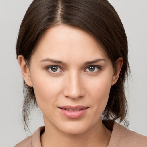 Joyful white young-adult female with medium  brown hair and brown eyes