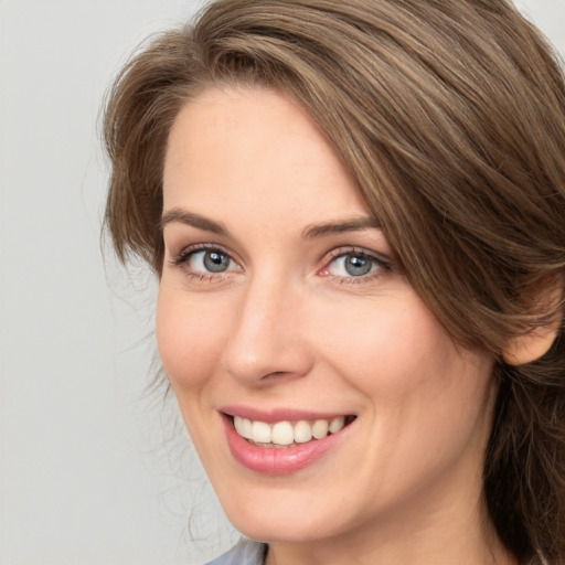 Joyful white young-adult female with long  brown hair and green eyes