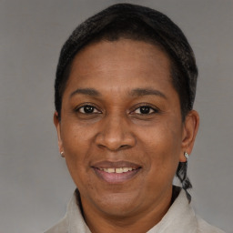 Joyful black adult female with short  brown hair and brown eyes