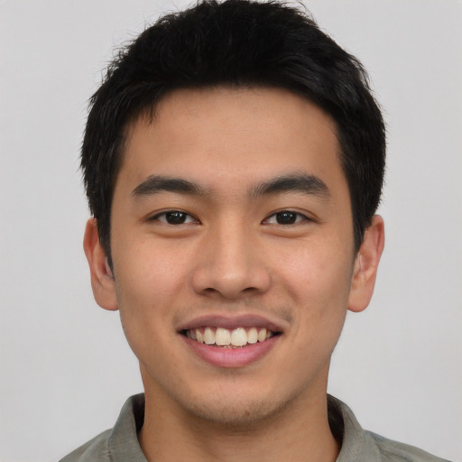 Joyful asian young-adult male with short  brown hair and brown eyes