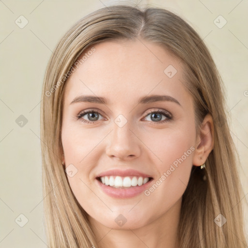 Joyful white young-adult female with long  brown hair and green eyes