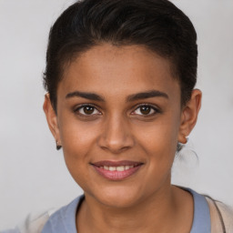 Joyful latino young-adult female with short  brown hair and brown eyes