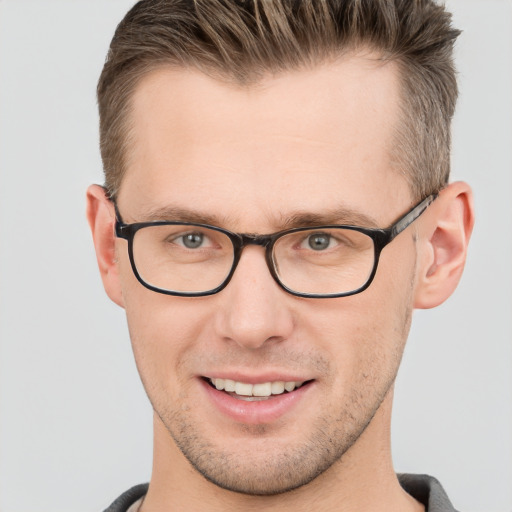 Joyful white adult male with short  brown hair and grey eyes