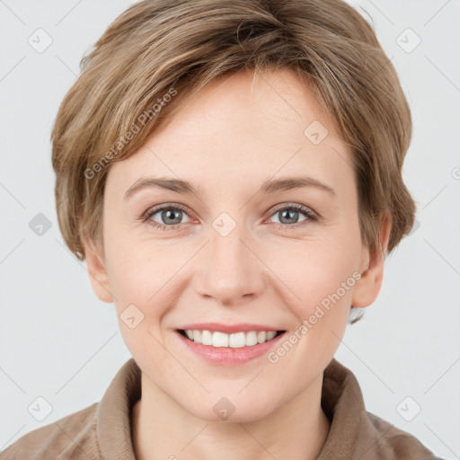 Joyful white young-adult female with short  brown hair and grey eyes