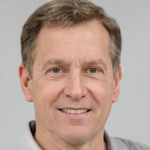 Joyful white middle-aged male with short  brown hair and grey eyes