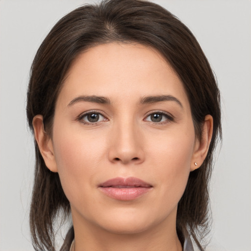 Joyful white young-adult female with medium  brown hair and brown eyes