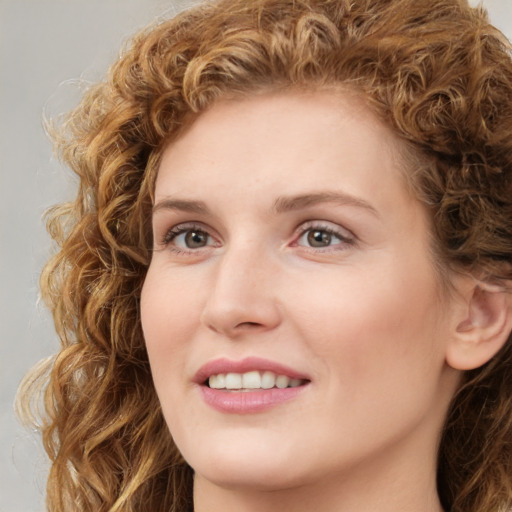 Joyful white young-adult female with long  brown hair and green eyes