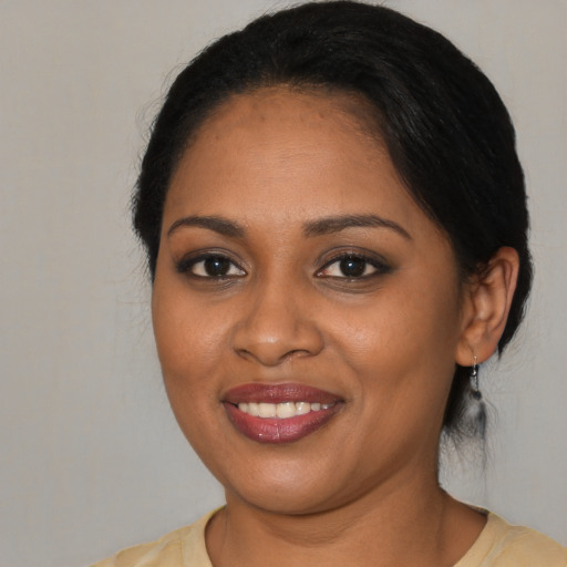 Joyful black young-adult female with medium  brown hair and brown eyes