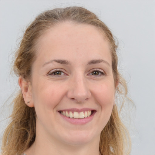 Joyful white young-adult female with long  brown hair and blue eyes